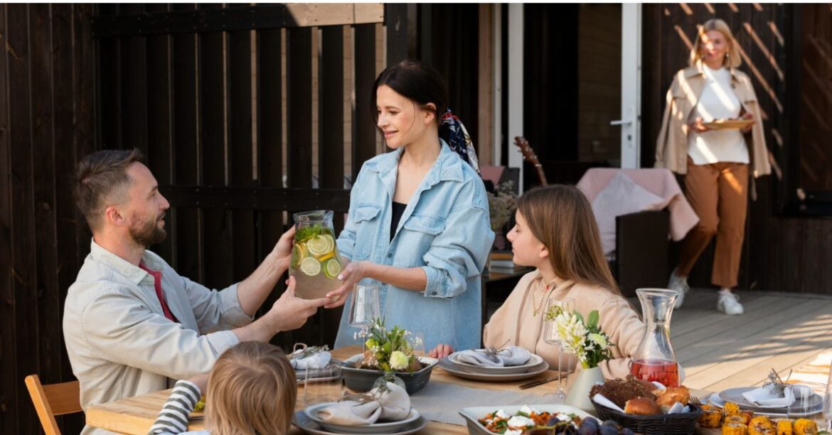 Family enjoying a meal together at an outdoor dining table at one of the best family restaurants in Orlando