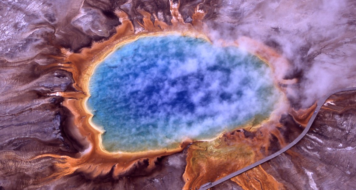 Aerial view of Grand Prismatic Spring with its deep blue center and orange bacterial mats