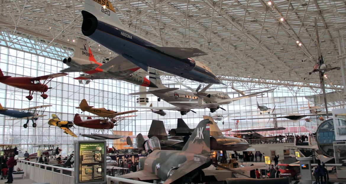 Historic aircraft suspended from the glass ceiling of the Great Gallery at the Museum of Flight in Seattle