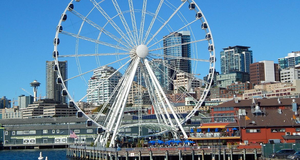 Seattle Great Wheel on Pier 57 with downtown towers and the Space Needle behind the waterfront