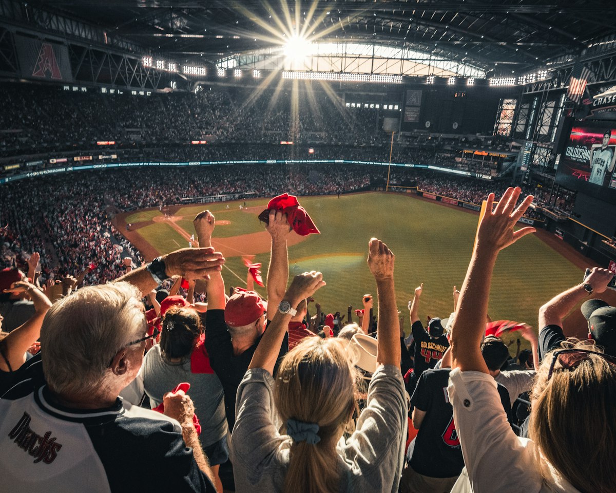 Baseball fans cheering in the stands at a stadium